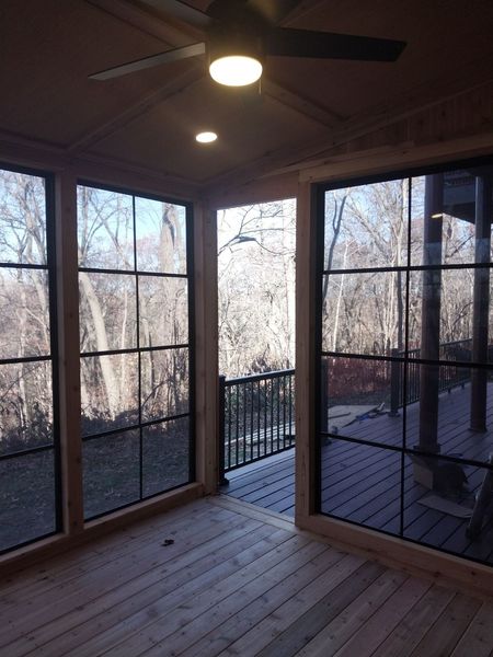 Four-season room at dusk with wood ceiling and recessed lights