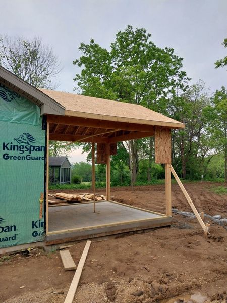 Framed porch roof over a new concrete slab