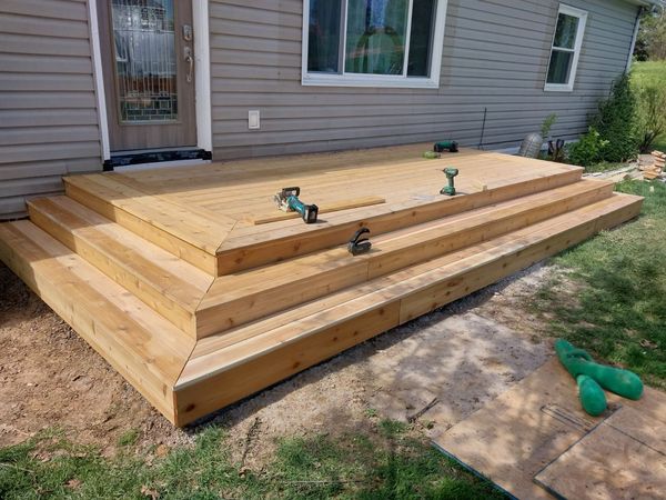 Tiered step-down cedar deck at a side entry door