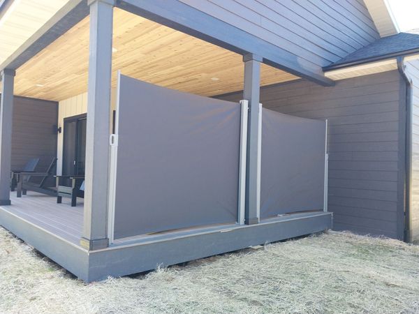 Retractable privacy shades on a covered back patio