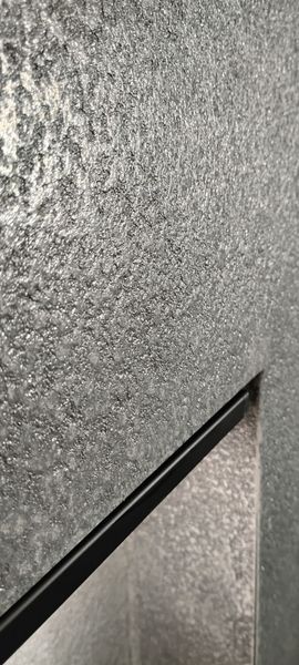 Close-up of hand-troweled microcement texture at a shelf edge
